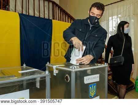 Velyka Dobron, Ukraine - October 25, 2020: Voters Wearing Protective Masks Vote In Local Elections D