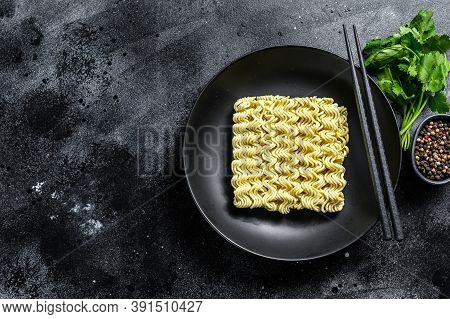 Dry, Raw Quick Cooking Noodle, Instant Noodles. Black Background. Top View. Copy Space