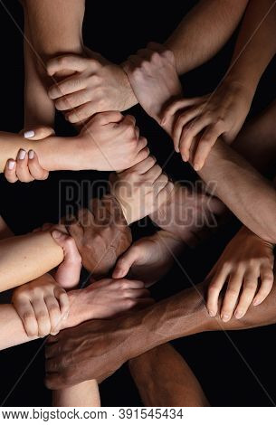 Together, Peace. Hands Of Peoples Crows In Touch Isolated On Black Studio Background. Concept Of Hum