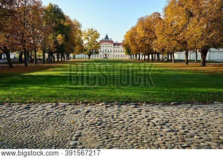 Paved Road, Park And Façade Of A Baroque Palace During Autumn In Rogalin