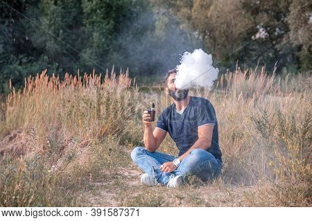 Brutal Vaper Smoking An Vape In The Fresh Air. Vaping Activity.