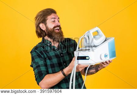 All You Need Is Iron. Man Ironing At Home. Happy Man Ironing Clothes. Man Concentrated On Ironing A 
