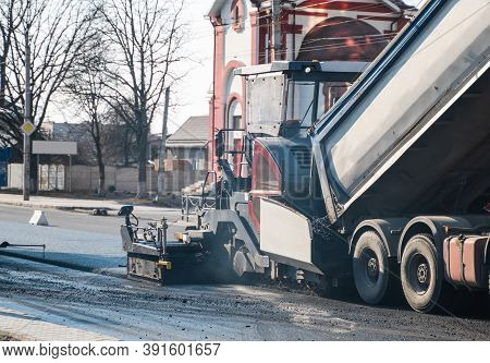Industrial Asphalt Paver Machine Laying Fresh Asphalt On Road Construction Site On The Street. A Pav