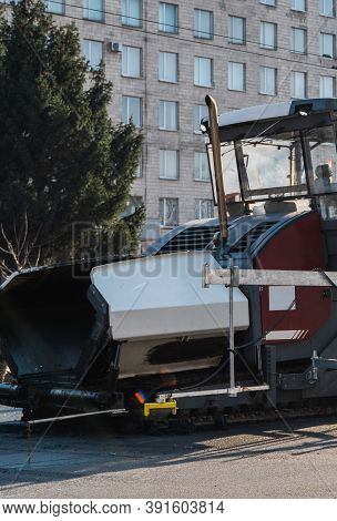 Industrial Asphalt Paver Machine Laying Fresh Asphalt On Road Construction Site On The Street. A Pav