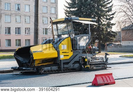 Industrial Asphalt Paver Machine Laying Fresh Asphalt On Road Construction Site On The Street. A Pav