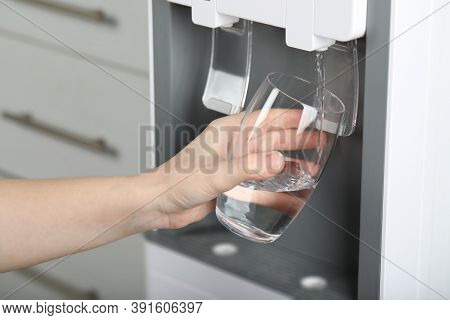 Woman Filling Glass With Water Cooler, Closeup. Refreshing Drink