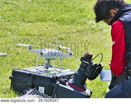 Jumieges, France - June Circa, 2019. Mature Male Technicians Outdoor, On Grass, Using Professional D
