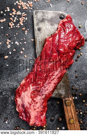 Raw Strip Vegas Steak On A Meat Cleaver. Black Background. Top View