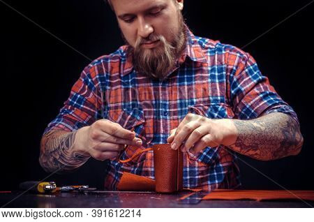 Man Working With Leather Forms New Leather Product At His Workshop