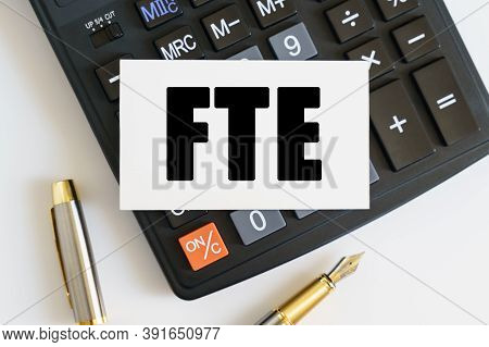 Business And Finance Concept. On The Table There Is A Pen, A Calculator And A Business Card On Which