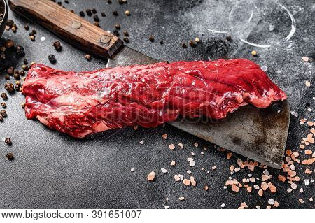 Raw Strip Vegas Steak On A Meat Cleaver. Black Background. Top View