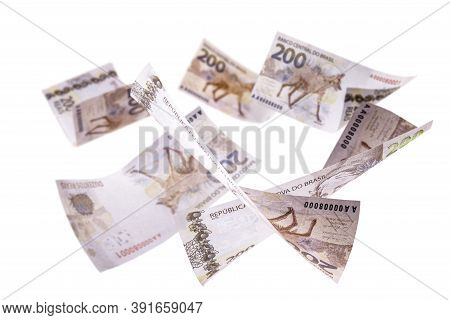 200 Reais Banknotes, Bank Notes Falling On Isolated White Background. Two Hundred Reais From Brazil,