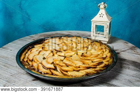 Handmade Apple Pie On A Wooden Table And A Blue Wall