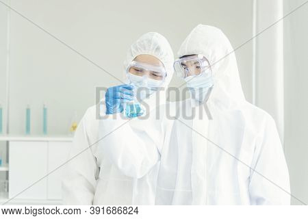 Two Asian Scientist Team Reserch Chemistry Science Tube Experiment Biotech Antibody Sample In Labora