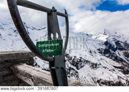 Pointer to the highest peak of the Alps - Grossglockner - 3798 meters. The first snow fell on Grossglockner Alpine Road. Austria. Ecological, active and photo tourism concept