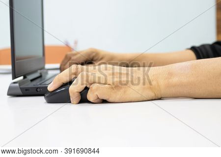 A Man Sitting Using A Laptop With Hand To Hold A Mouse Show Office Syndrome Concept With Weire Wrist