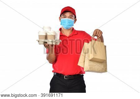Happy Young Asian Delivery Man In Red Uniform, Medical Face Mask Carry Bags Of Food And Drink In Han