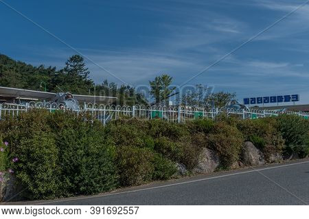 Military Aircraft Parked Behind Fence At Military Theme Park