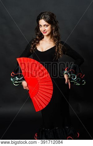 Portrait Of Beautiful Young Woman Dancing Flamenco In Studio