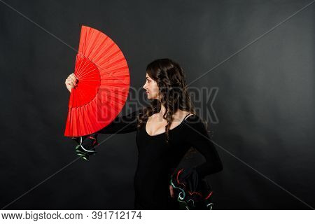 Portrait Of Beautiful Young Woman Dancing Flamenco In Studio