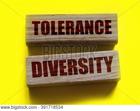 Tolerance Diversity Words On Wooden Blocks On Yellow. Equality Concept By Gender, Ethnicity And Age