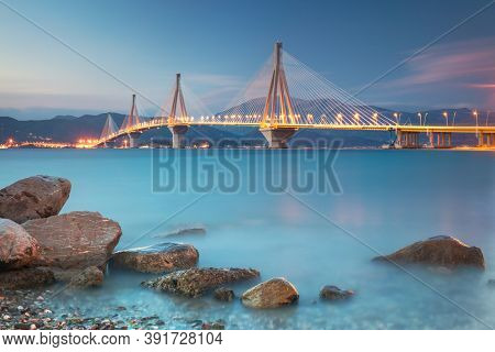 Urban view - Modern Bridge at the evening night time with illuminations. Rion-Antirion Bridge, Greece, Europe. The Rion-Antirion Bridge in Greece 