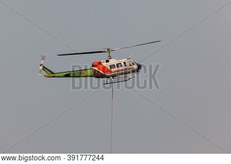 Prospect,  Oregon / Usa - September 13, 2014:  A Fire Fighting Helicopter Takes Off In A Smoke Fille