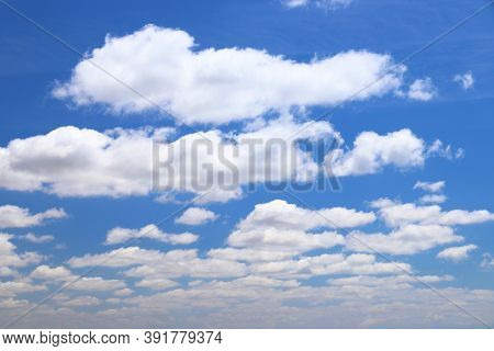 White Clouds Blue Sky Background. White Fluffly Clouds Texture.
