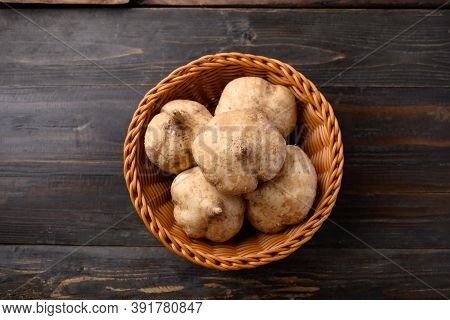Fresh Jicama Or Yam In A Basket On Wooden Background, Jicama Can Be Eaten Raw Or Cooked, The Taste A