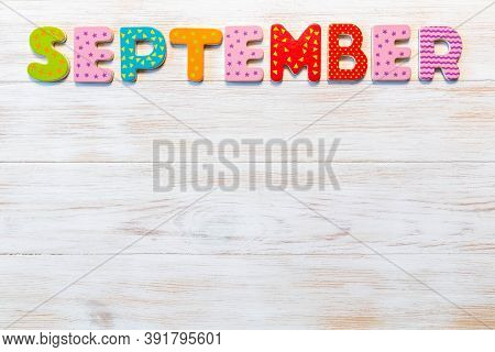 Wooden Letters Written September Month On Vintage Background. Inscription September With Copy Space.