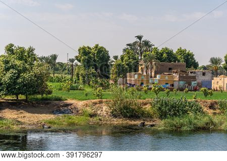 Egyptian Local People Living On The Bank Of The River Nile. Views Sailing On The Cruise On The River