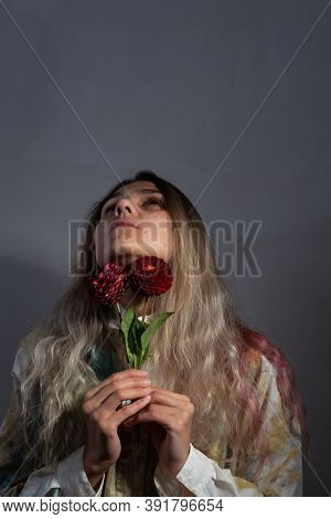 Sore Throat Concept. The Girl Holds Red Flowers At Her Throat. Sore Throat With Angina, Pharygitis, 