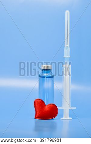 Transparent Medical Ampoules And A Red Heart On A Light Blue Background. Concept: Medicine, Saving L
