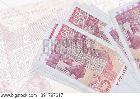 20 Croatian Kuna Bills Lies In Stack On Background Of Big Semi-transparent Banknote. Abstract Presen