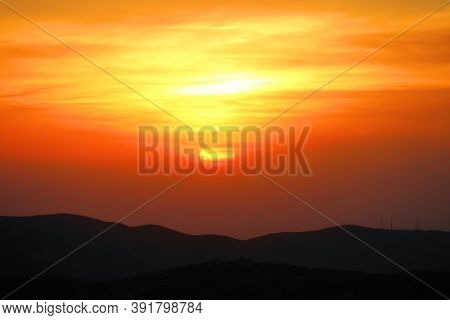 Sun Setting Through A Layer Of Smoke Caused From A Wildfire Over Rural Badlands Taken In The Parched