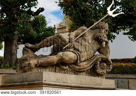 Rococo Chateau From The 18th Century, Poseidon With Trident, Baroque Statues Decorating The Garden F
