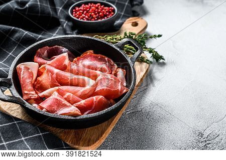 Italian Rolled Bacon Pancetta Piacentina. Pork Meat. White Background. Top View. Copy Space