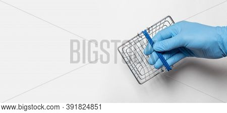 Shopping Metal Empty Basket In Male Hand In Blue Protecive Glove. Shopping During Coronavirus Lockdo