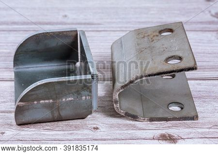 Tool And Equipment For Bending Sheet Metal On A Wooden Background. Folded Sheet Metal Products.