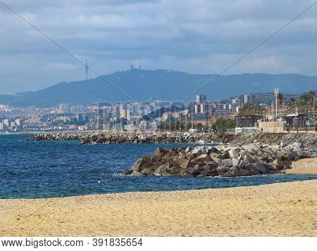 Barcelona Skyline And Sailingboat In Mediterranean Sea