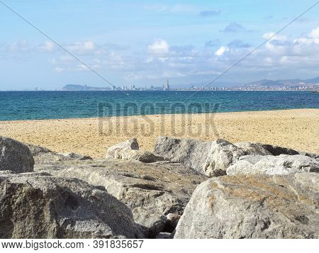 Barcelona Skyline And Sailingboat In Mediterranean Sea