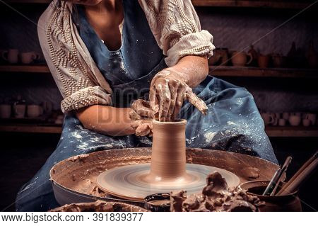 Potter Master Woman Is Working On Pottery Wheel. Pottery Workshop. Close-up.