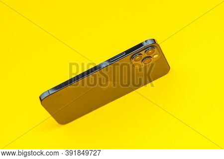 Paris, France - Oct 23, 2020: Yellow Background With New Iphone 12 Pro Max 5g Smartphone Model By Ap