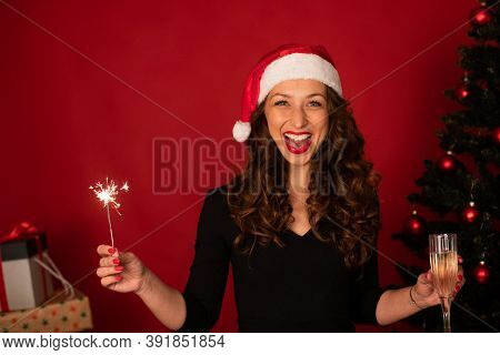 Holiday New Year Card With Pretty Girl Laughing. Beautiful Long-hair Brunette Girl In Santa Claus Ha