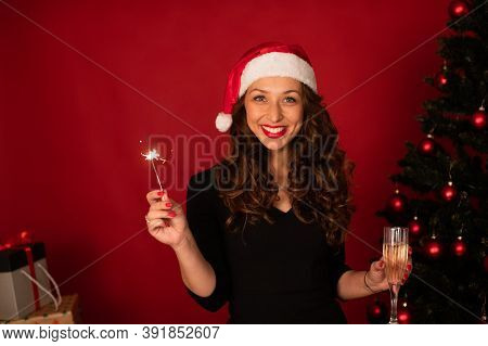 Beautiful Long-hair Brunette Girl In Santa Claus Hat Sends Christmas Greetings To Her Loved Ones By 