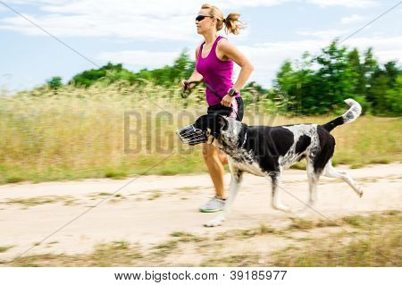 Woman Runner Running, Walking Dog In Summer Nature