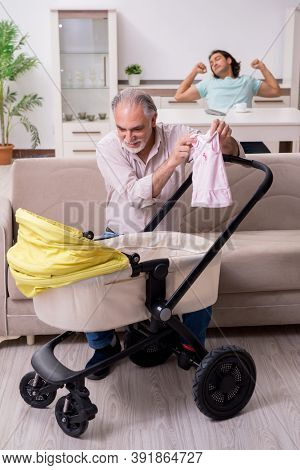 Retired grandfather looking after newborn at home