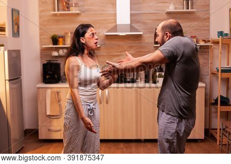 Furious Couple Fighting In The Kitchen, Family With Violence Issues. Traumatised Helpless Terrified 