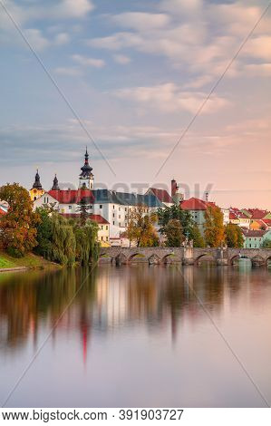 Pisek, Czech Republic. Cityscape Image Of Pisek With Famous Stone Bridge At Beautiful Autumn Sunset.