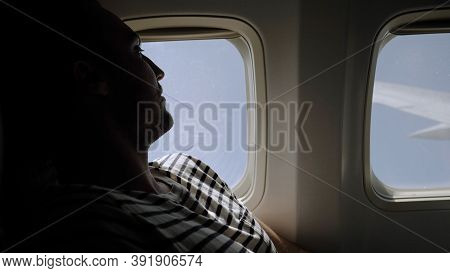 Passenger Traveler Looking At Window In Airplane, Travel By Flig